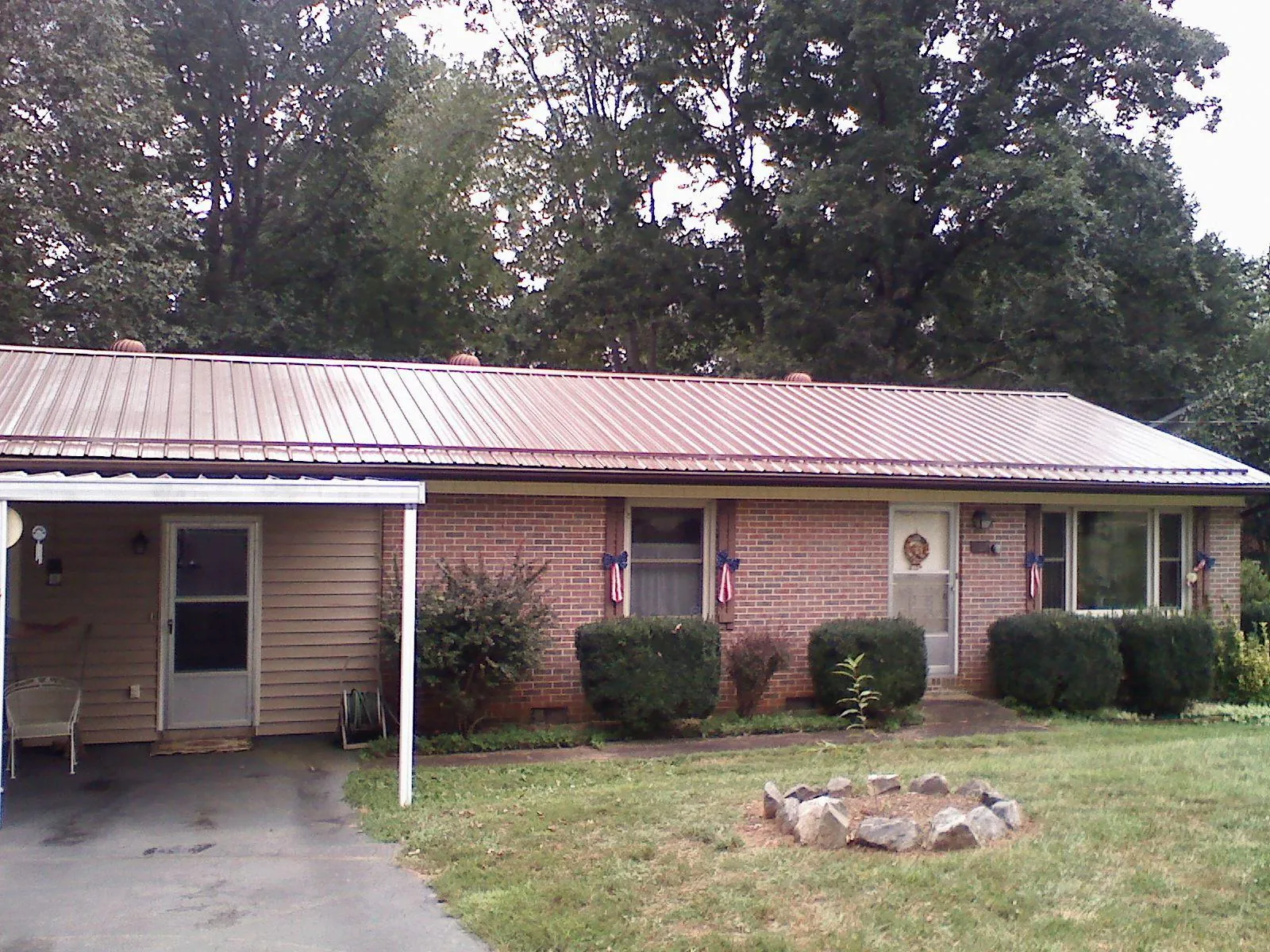 Bronze metal roof and carport on a brick ranch home — Roof Repair work by our crew in Glen Lyon